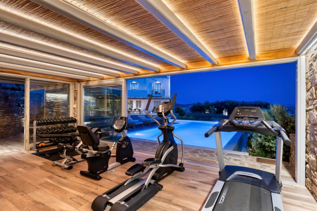 villa-fiona_53-m-four-villa-gym-with-pool-view-at-night-time